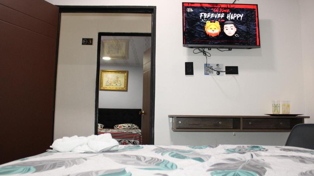 Postel nebo postele na pokoji v ubytování Hostal Queens Deluxe