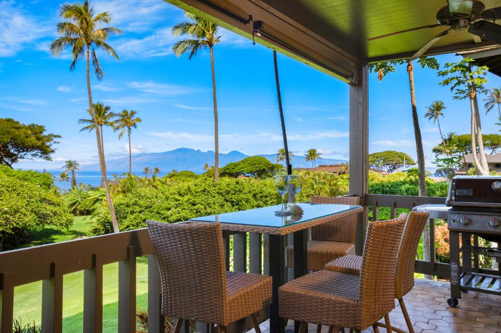 a porch with a table and chairs and a grill at K B M Resorts: Kaanapalii Plantation Villa KPL-55 Partial Ocean Views Includes Rental Car in Kaanapali