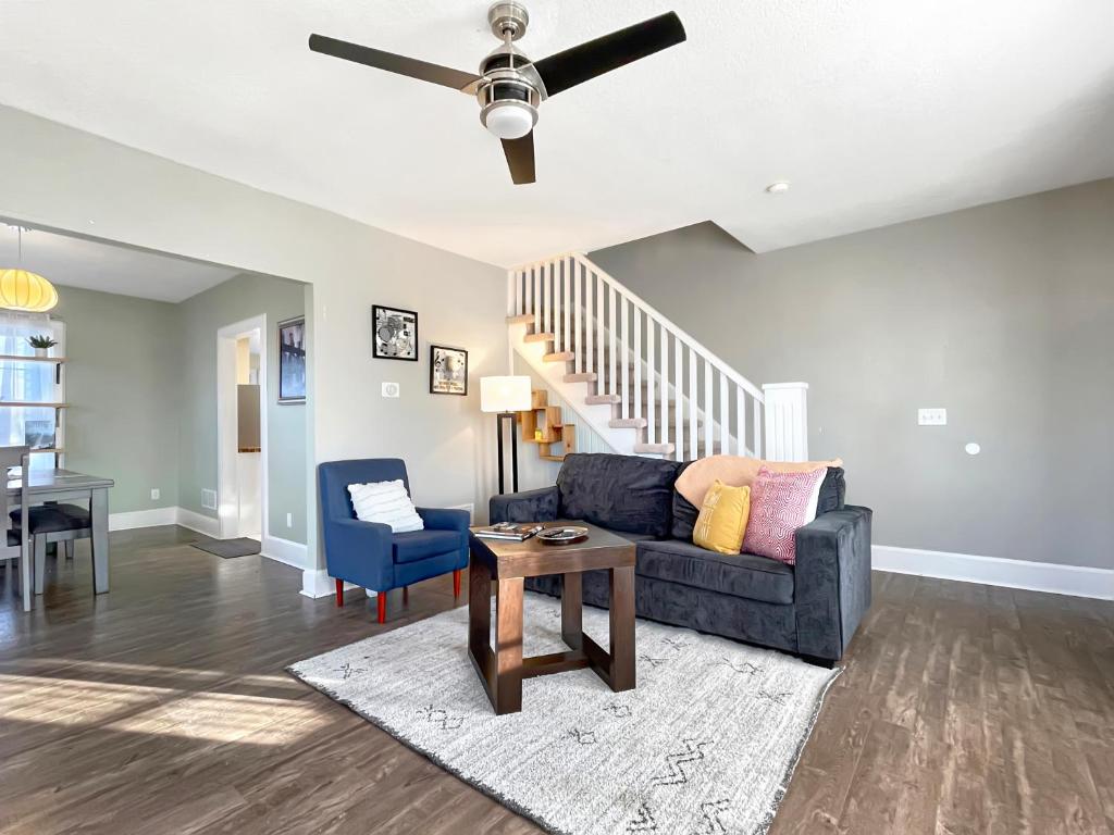 a living room with a couch and a table at 2br Family Charmer Duplex Near Drake in Des Moines