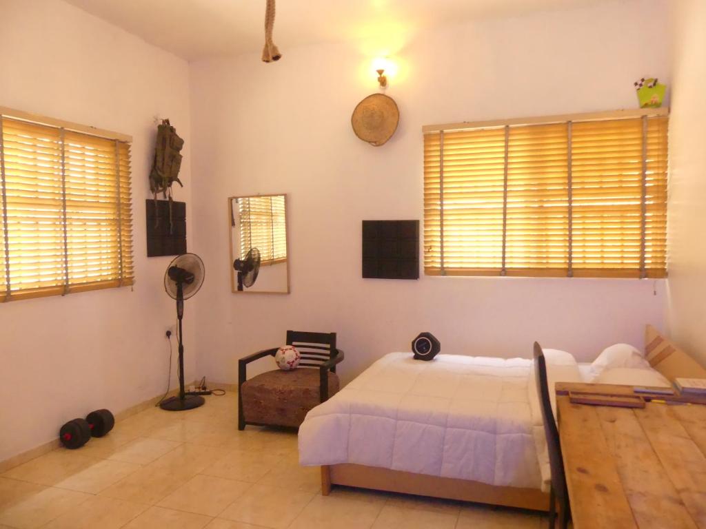 1 dormitorio con 1 cama y 2 ventanas en Templar's court, en Port Harcourt