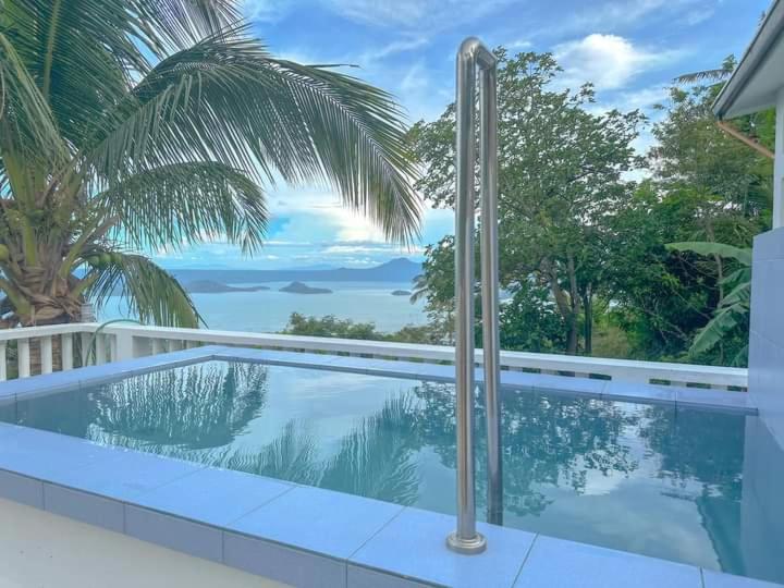 a swimming pool with a view of the ocean at Cabin de Paulin 2 in Tagaytay