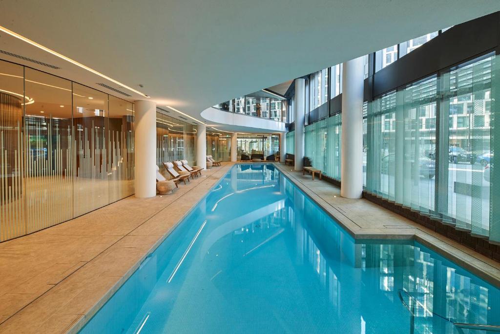 a large swimming pool in a building at High-Rise on Collins with Free Parking, Pool, Gym in Melbourne