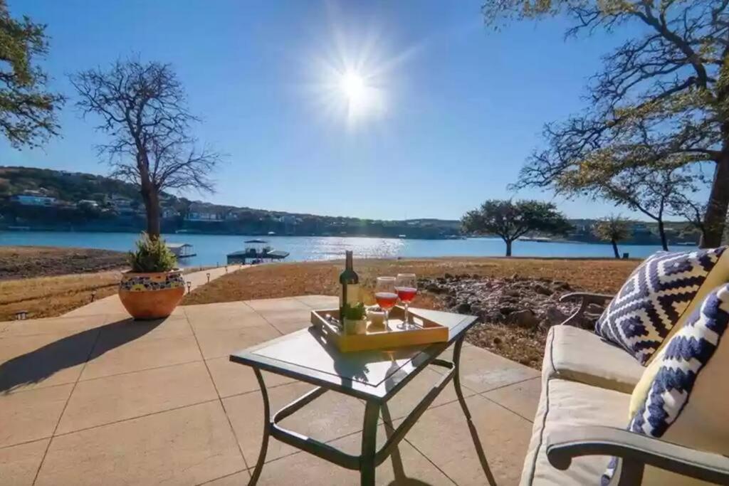 a patio with a table with a bottle of wine at Lake Travis with Private Dock on Deep Water Cove in Lago Vista