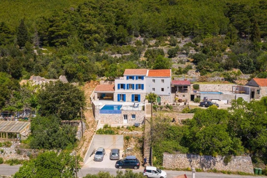 an aerial view of a house with a parking lot at Family friendly house with a swimming pool Babino Polje, Mljet - 22326 in Babino Polje