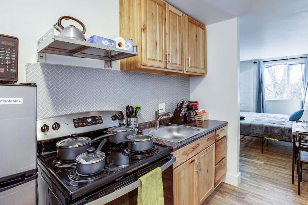 a kitchen with pots and pans on a stove at Studio w/ King Bed near Dwtn in Rochester