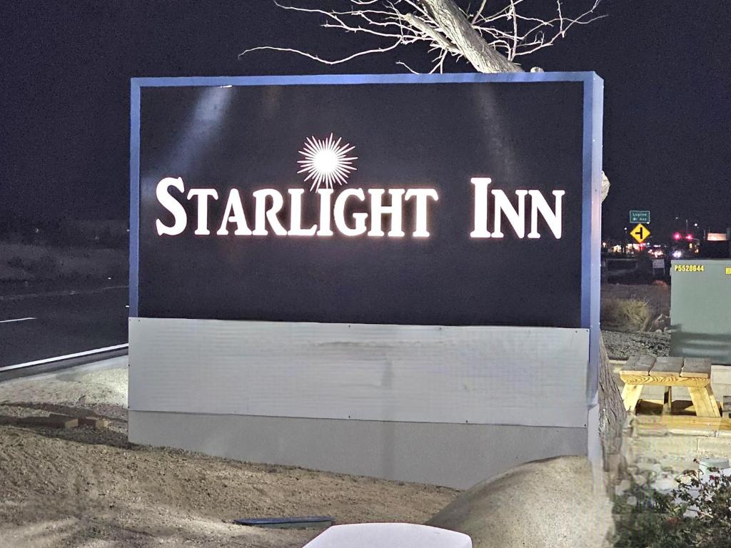 a sign for a starrett inn on the side of a road at Starlight Inn Joshua Tree - 29 Palms in Twentynine Palms