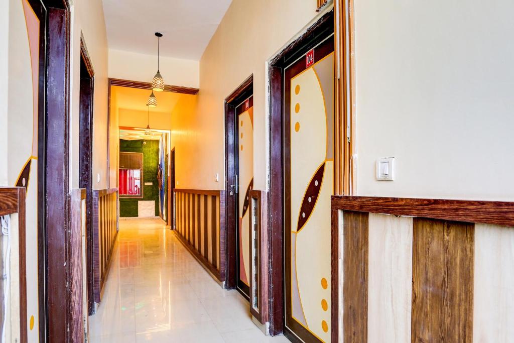 a hallway of a house with wooden doors at OYO ALASKA HOTEL in Alwar