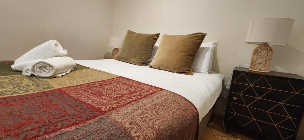 a bedroom with a large bed with a pillow and a lamp at Centre Collins in Melbourne