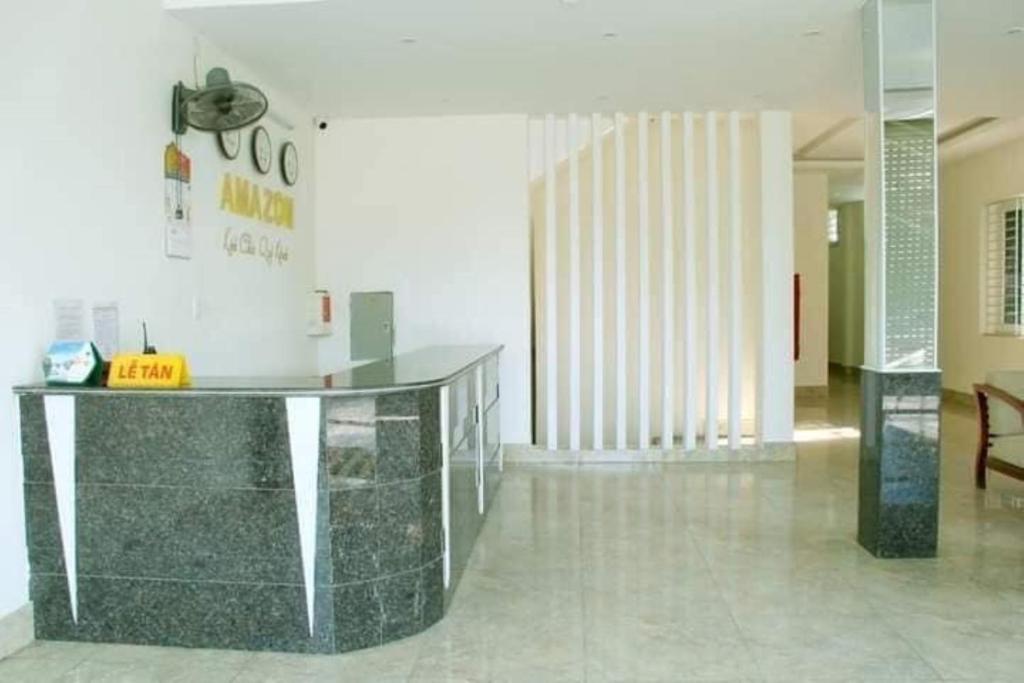 a lobby with a glass counter in a room at Amazon Hotel in Vinh