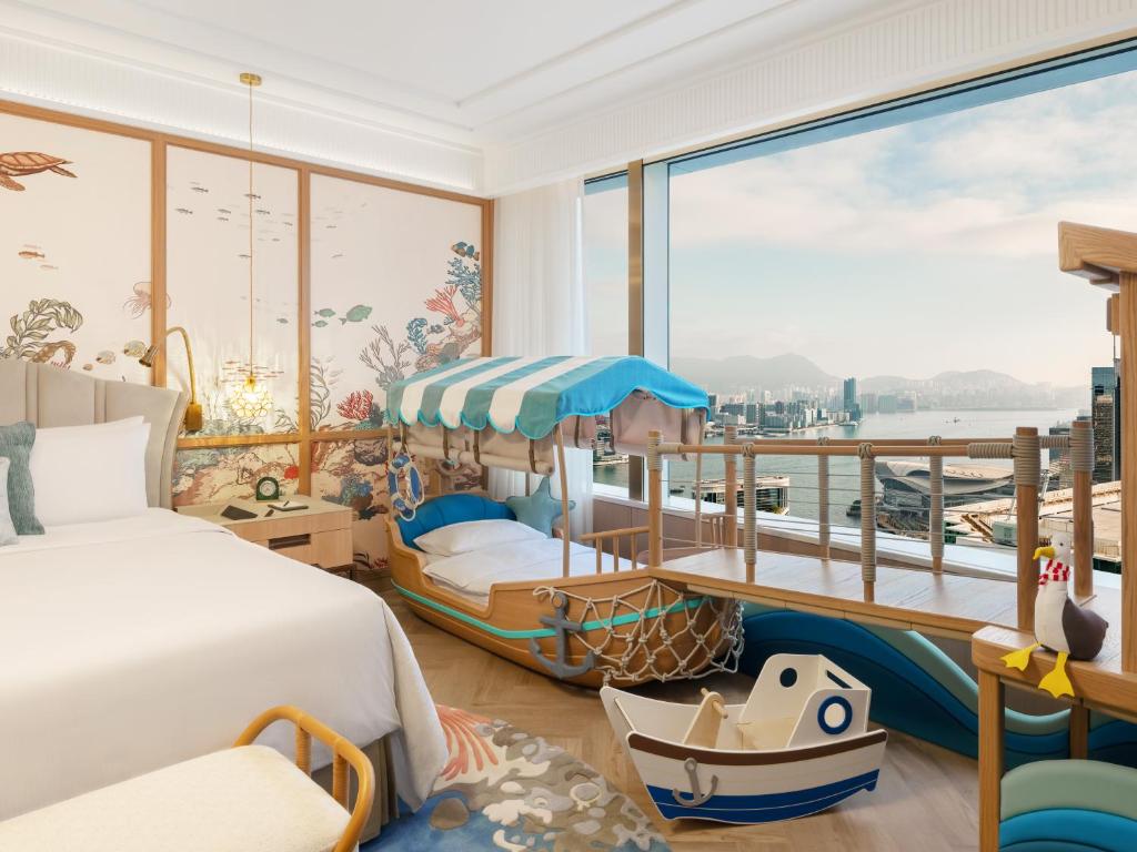 a bedroom with a bed and a balcony at Island Shangri-La, Hong Kong in Hong Kong