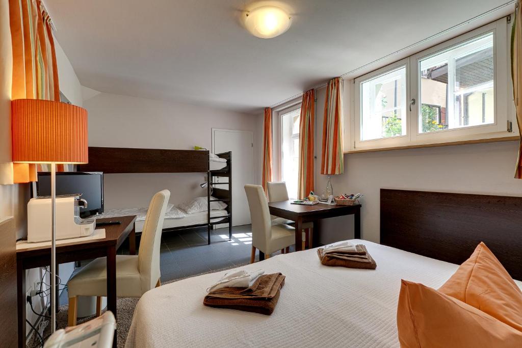 a hotel room with a bed and a desk with a computer at Hotel Kleine Radlerherberge in Möckmühl