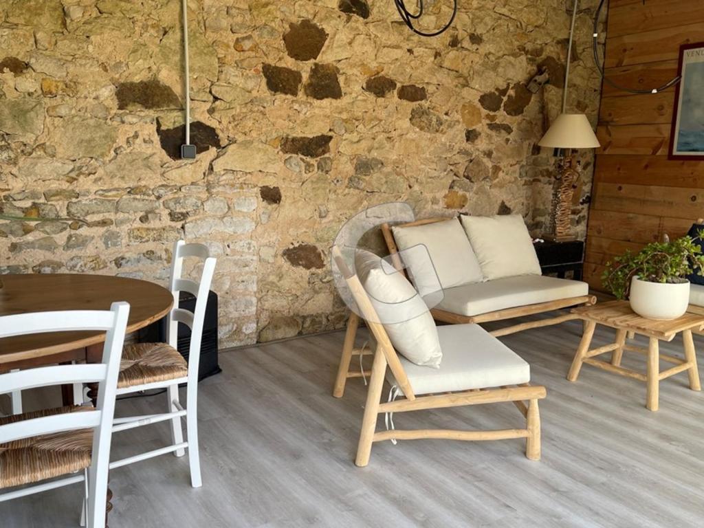 a room with a table and chairs and a table and a couch at Maison Le Bernard, 5 pièces, 6 personnes - FR-1-357-253 in Le Bernard