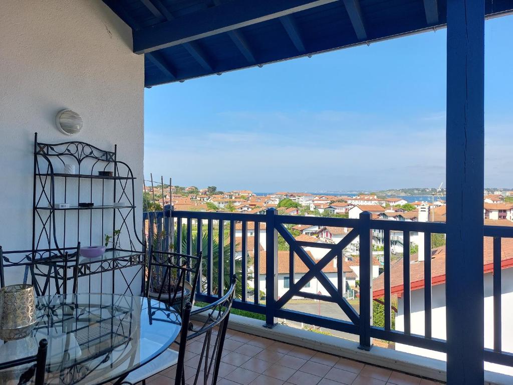 a balcony with a table and chairs and a view at Appartement Urrugne, 3 pièces, 6 personnes - FR-1-239-772 in Urrugne