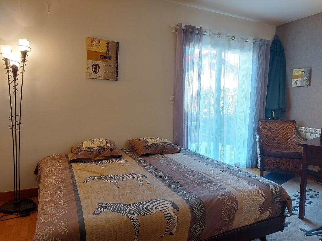 a bedroom with a bed with a zebra design on it at Appartement Urrugne, 3 pièces, 6 personnes - FR-1-239-772 in Urrugne