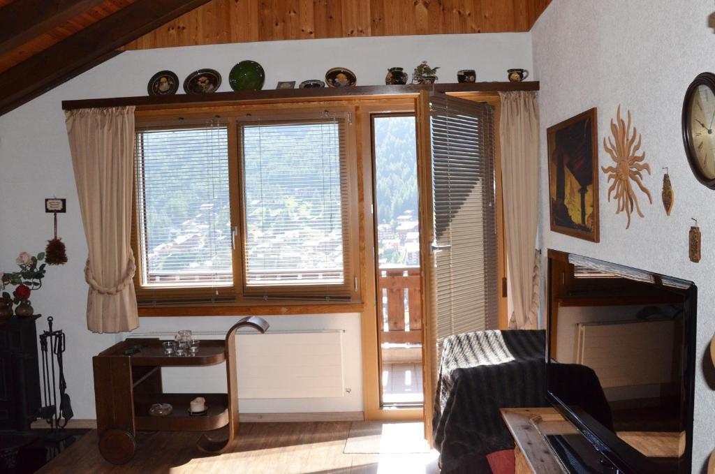 a living room with a large window with a view at Chalet Memory in Zermatt