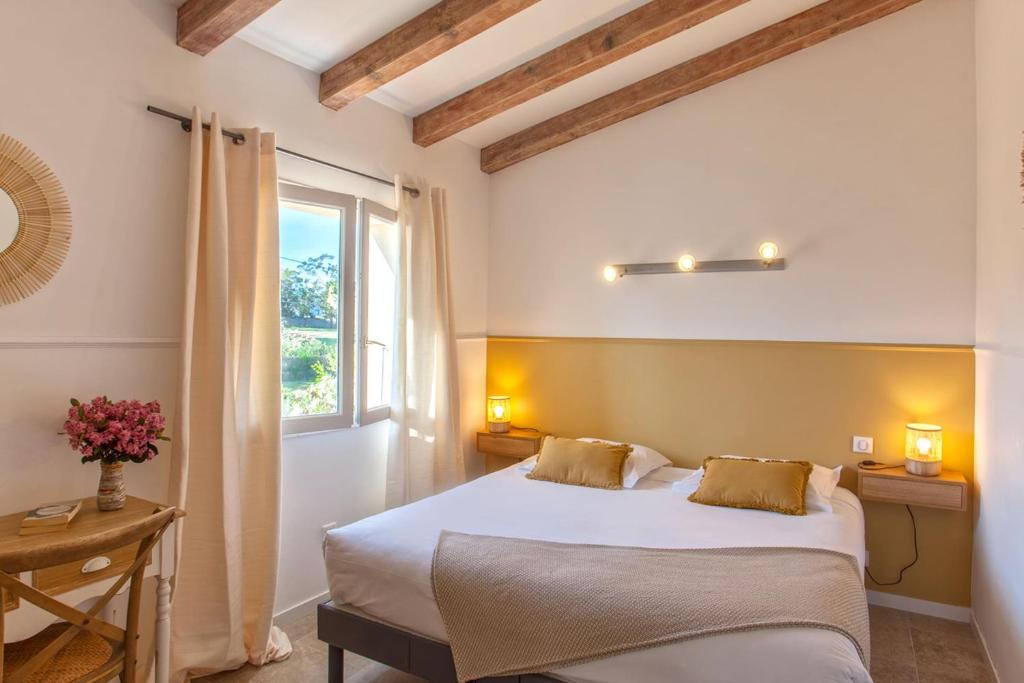 a bedroom with a large bed and a window at Beautiful Apartment Hortensia with large terrace for 46 people in Calvi