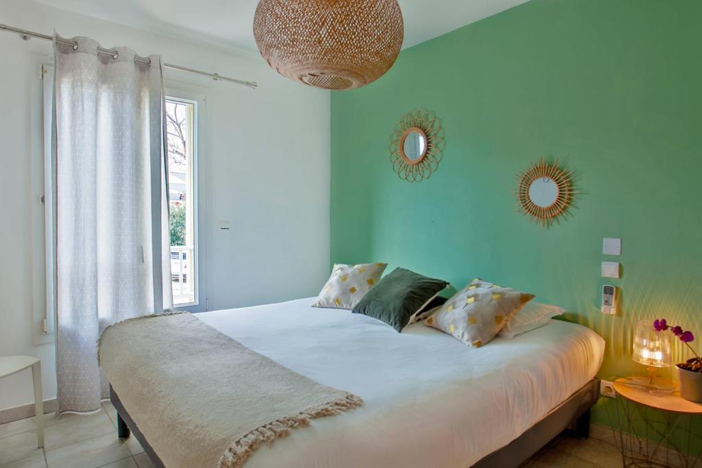 a bedroom with a large bed with blue walls at Apartment "Jasmin" 3 bedrooms with large terrace 68 people in Calvi