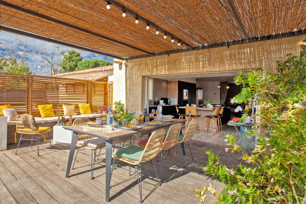 an outdoor patio with a table and chairs at Apartment "Jasmin" 3 bedrooms with large terrace 6 8 people in Calvi