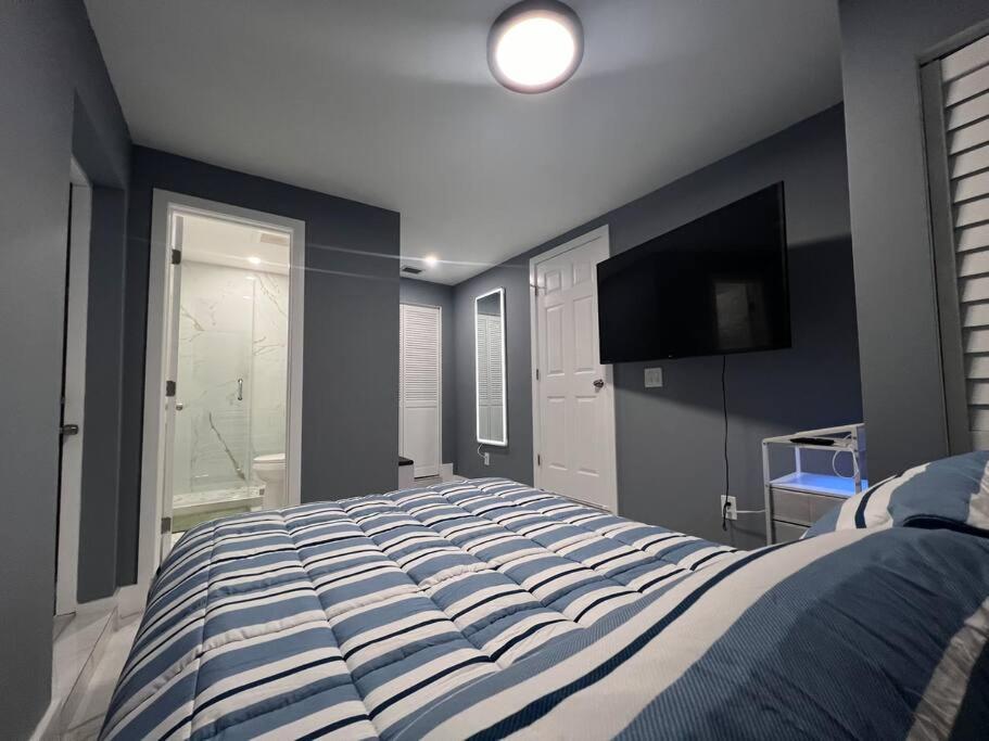 um quarto com uma cama grande e uma televisão de ecrã plano em Modern apartment near Wynwood! em Miami