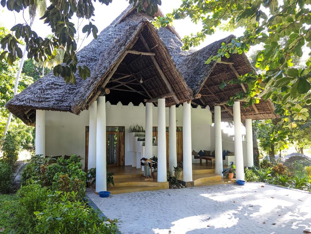 a house with a roof with a porch at Kivulini Lodge in Utende