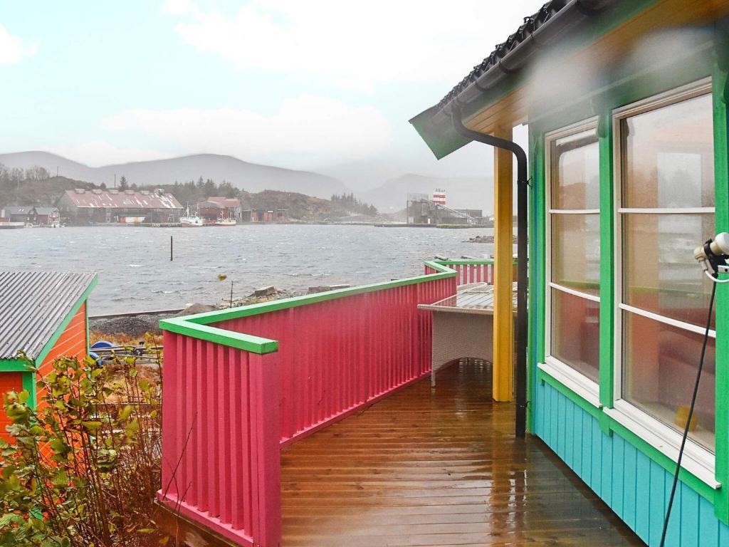 a colorful house with a view of the water at 6 person holiday home in M L Y in Måløy