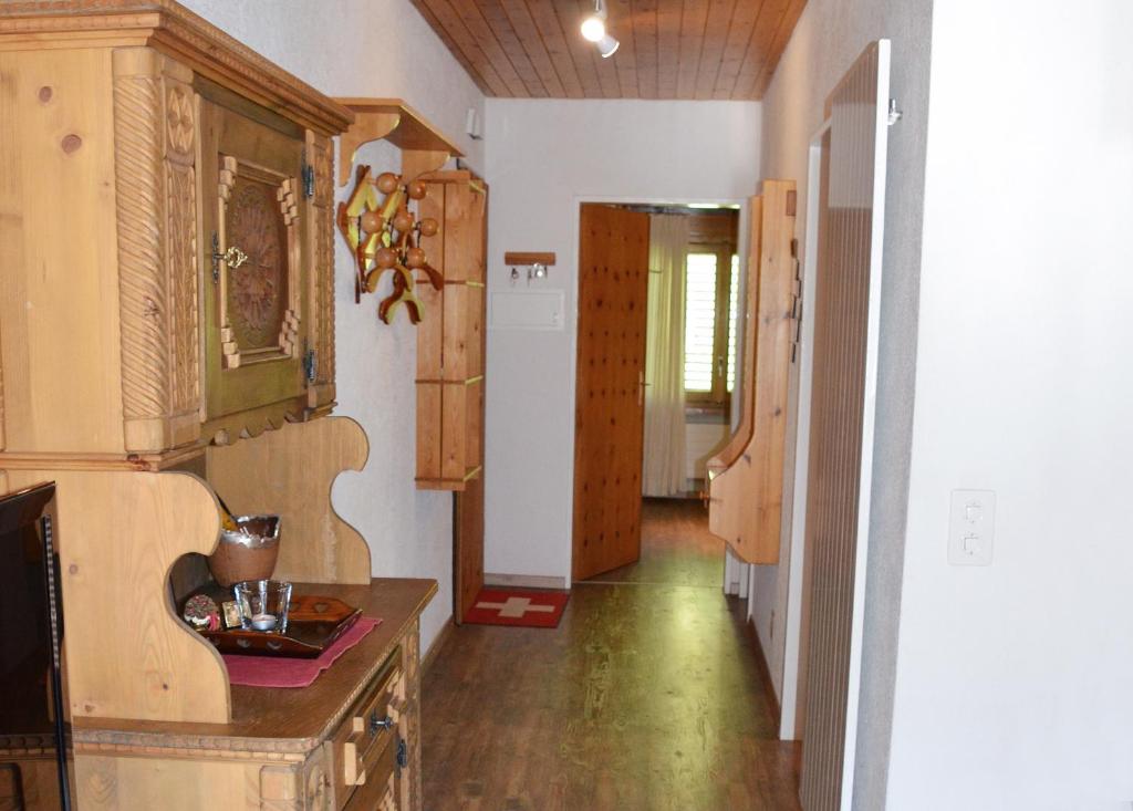a room with a kitchen with a counter and a hallway at Chalet Memory in Zermatt