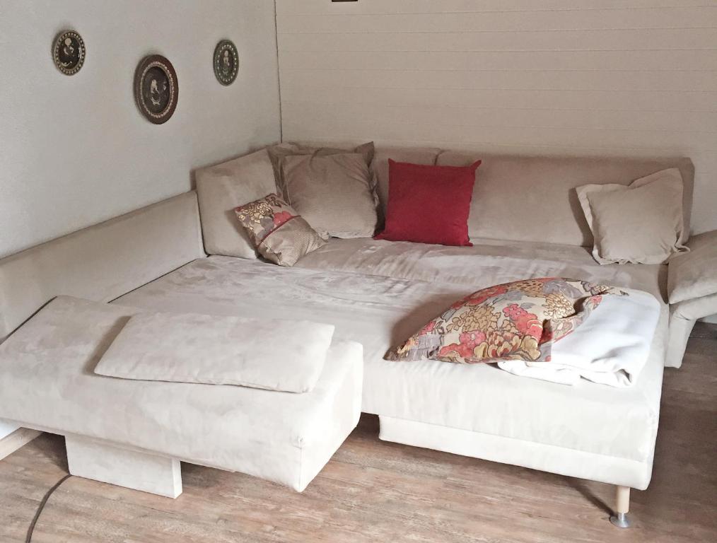 a white couch with pillows on it in a room at Chalet Memory in Zermatt