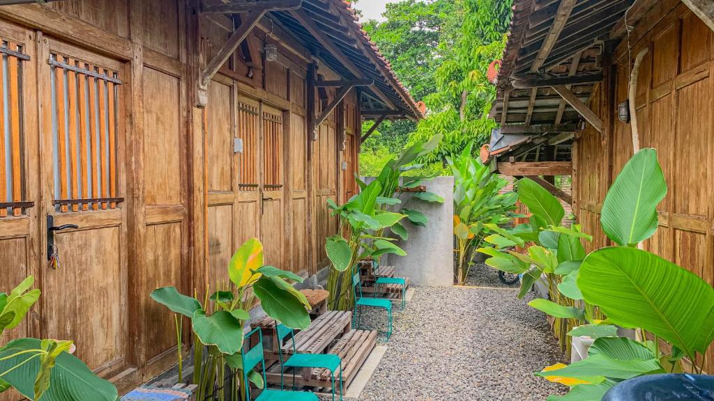 a courtyard with benches and plants in a building at Yukke Tembi Homestay in Yogyakarta