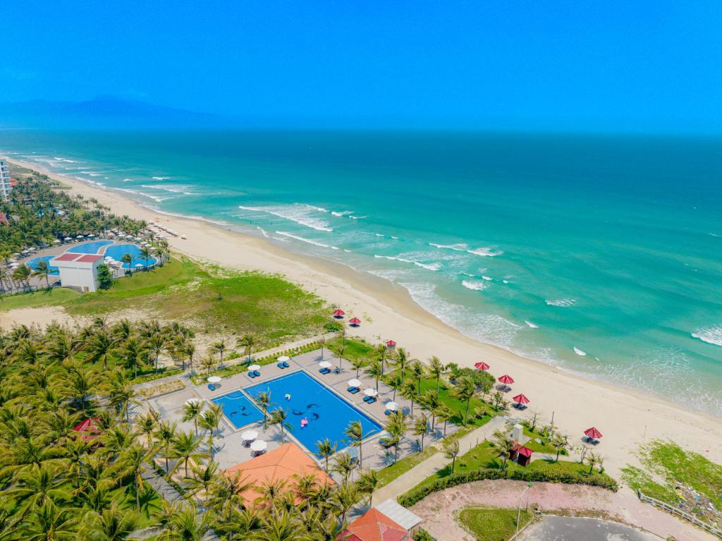 an overhead view of a beach with a pool and the ocean at Tuana Hotels Cam Ranh Resort in Cam Lâm