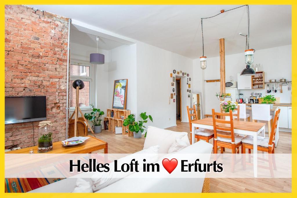 a living room with a couch and a table at Helles Altbau-Loft mit Kingsize Bett, Smart-TV, etc in Erfurt