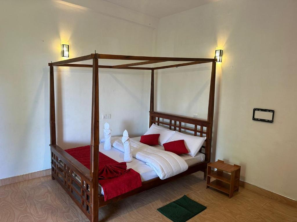 Postel nebo postele na pokoji v ubytování T-More Hotel & Hostel