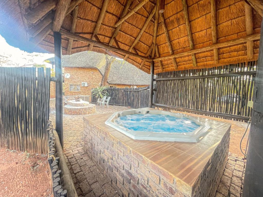 an outdoor hot tub in a pavilion at Walking Tall Private Bush Retreat in Marloth Park