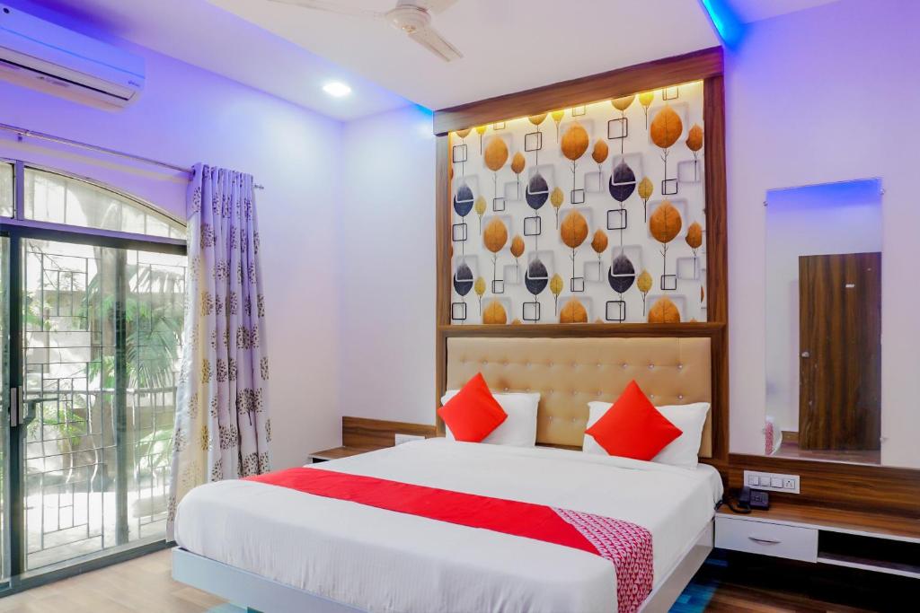 a bedroom with a large bed and a window at Collection O Hotel Rest Inn in Yeraoda