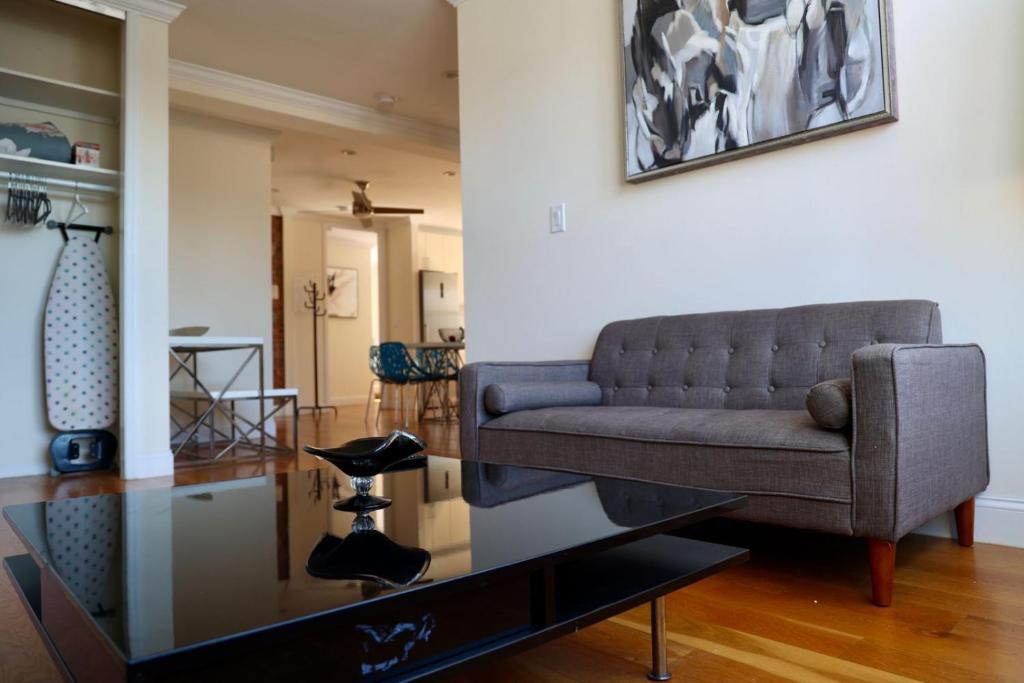 a living room with a couch and a glass table at Apartment in New York By Central Park in New York