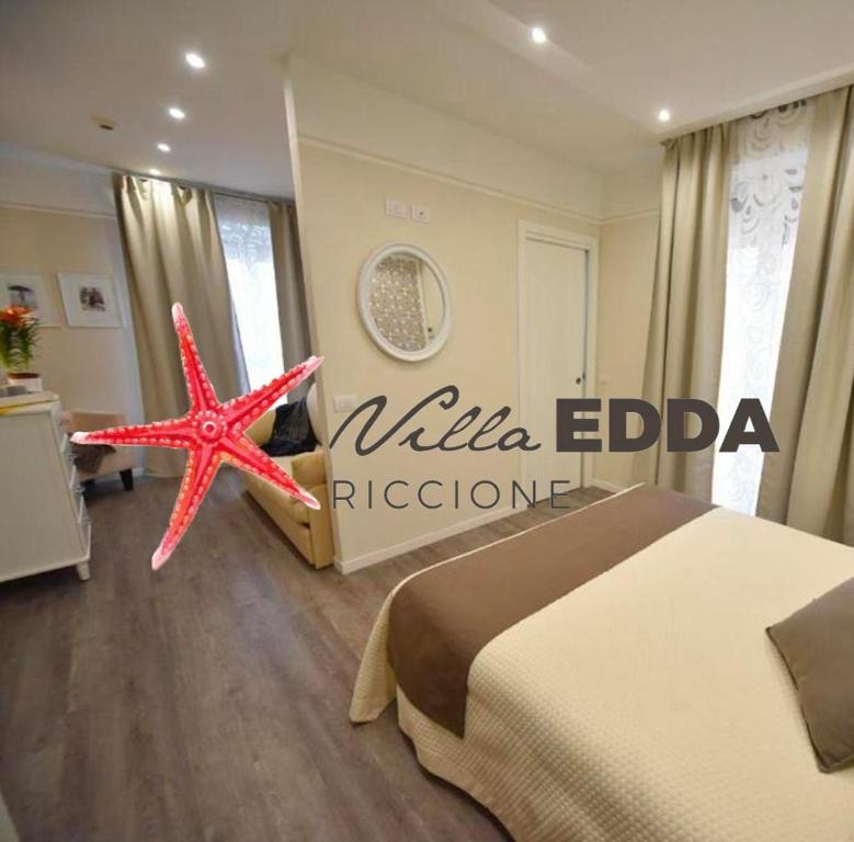 a bedroom with a bed and a starfish on the floor at Hotel Villa Edda in Riccione