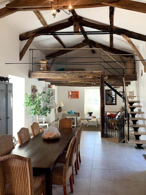 une salle à manger avec une table et des chaises en bois dans l'établissement ✰Chaleureuse Quercynoise avec piscine & jolie vue✰, à Montcuq