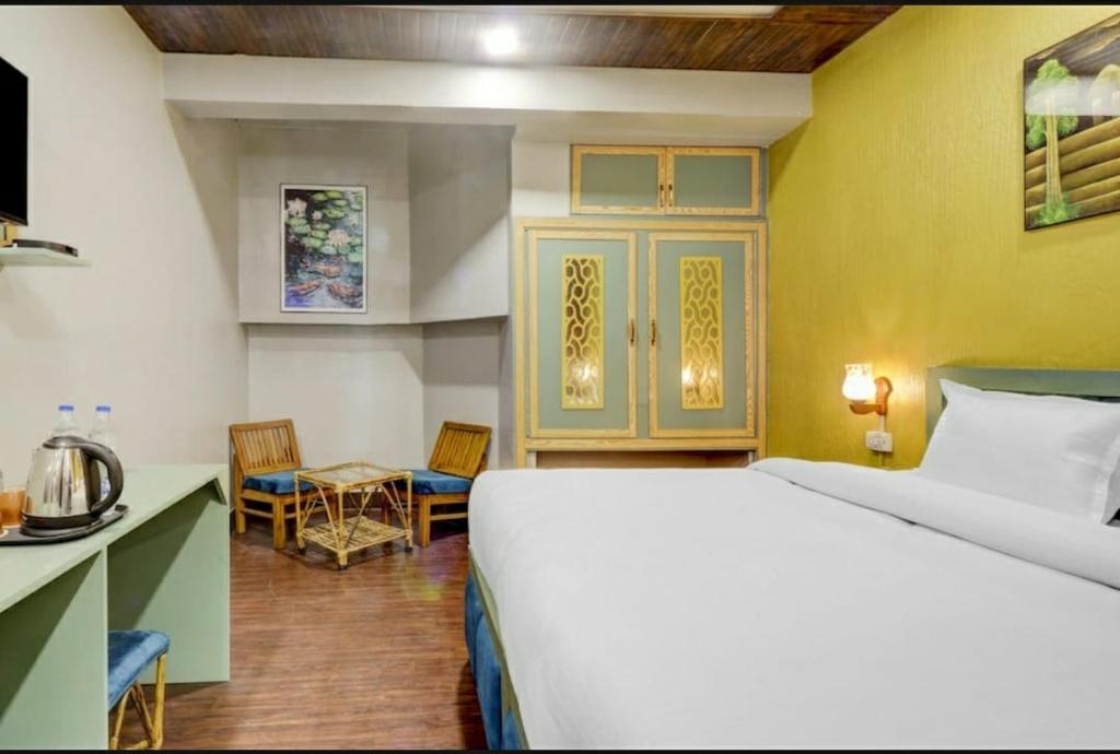 a hotel room with a bed and a kitchen at Hi hotel By Madras in Rishīkesh