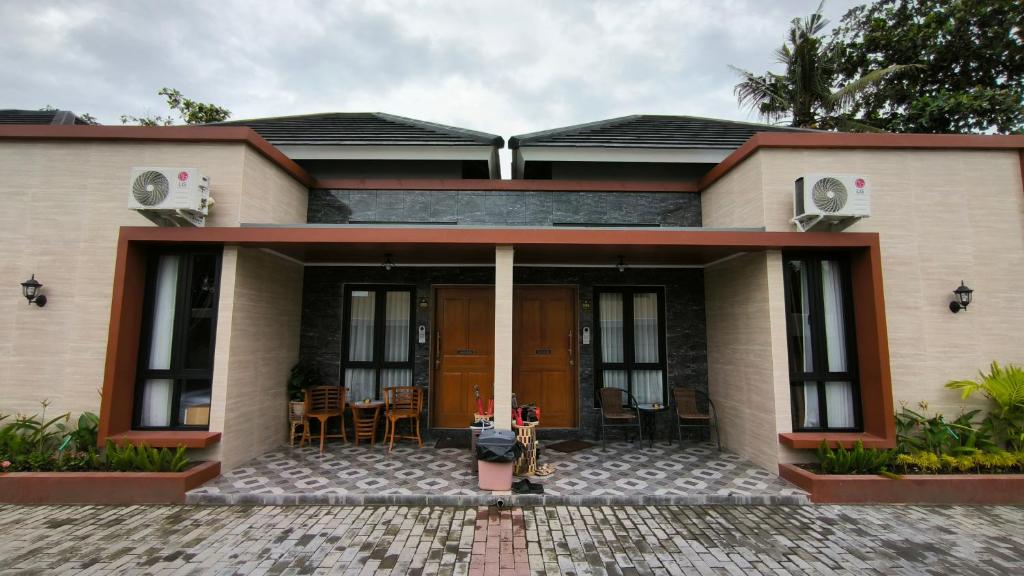 a house with a front porch with a patio at Premier Homestay Syariah in Kalasan