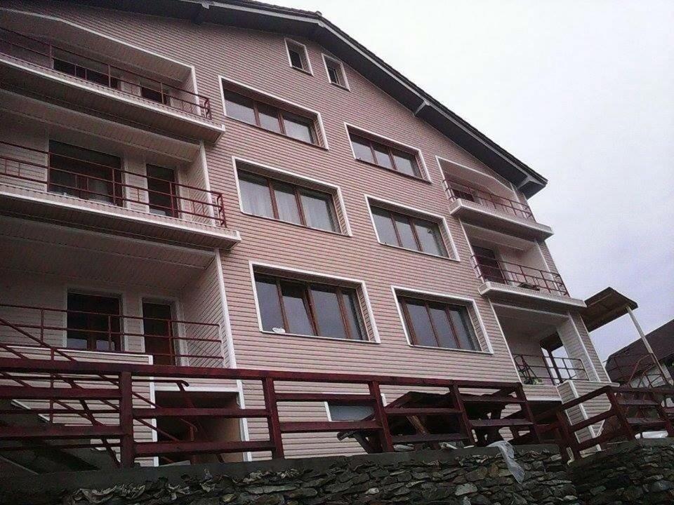 a large building with balconies on the side of it at Pensiunea Roka in Ranca