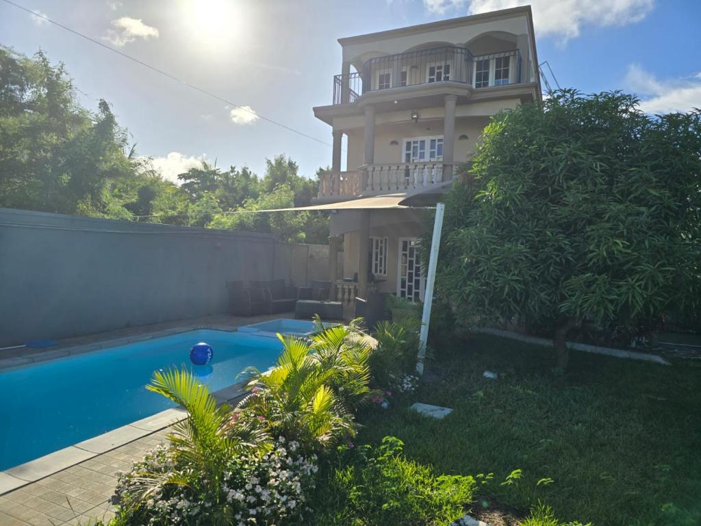 a house with a swimming pool in the yard at Serenity northen 6-beds villa with private pool in Grand-Baie