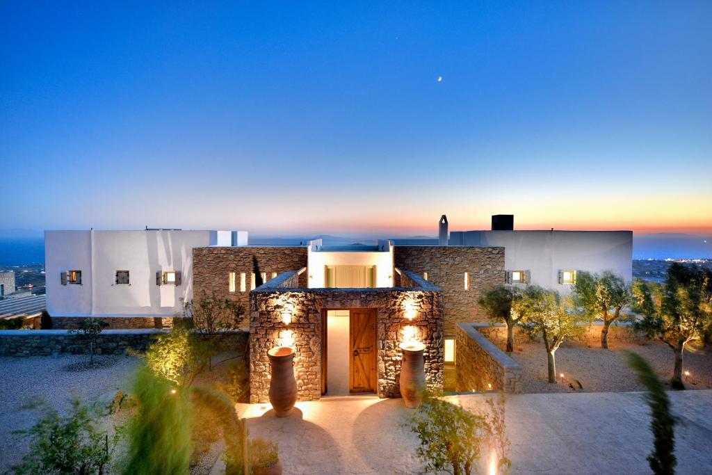 a house with lights on the front of it at Villa Alabaster by Mykonos Rocks in Klouvas