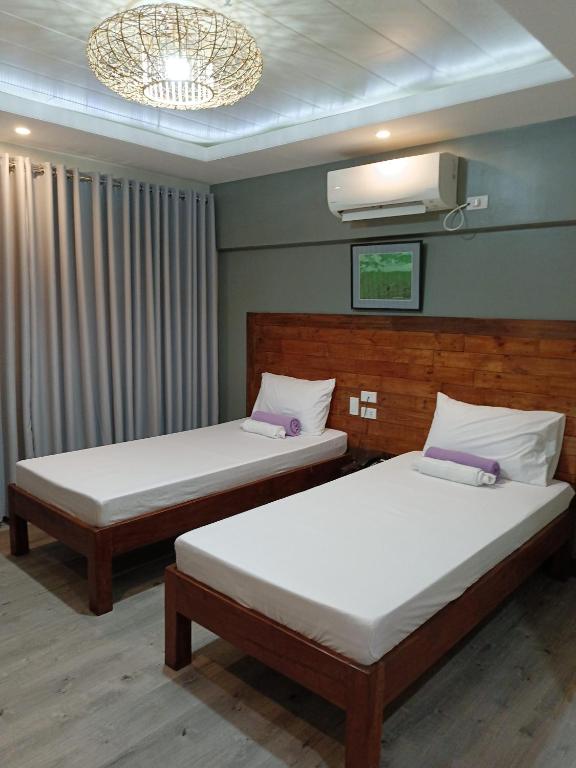 Postel nebo postele na pokoji v ubytování Norlu Cedec Midpoint Hotel