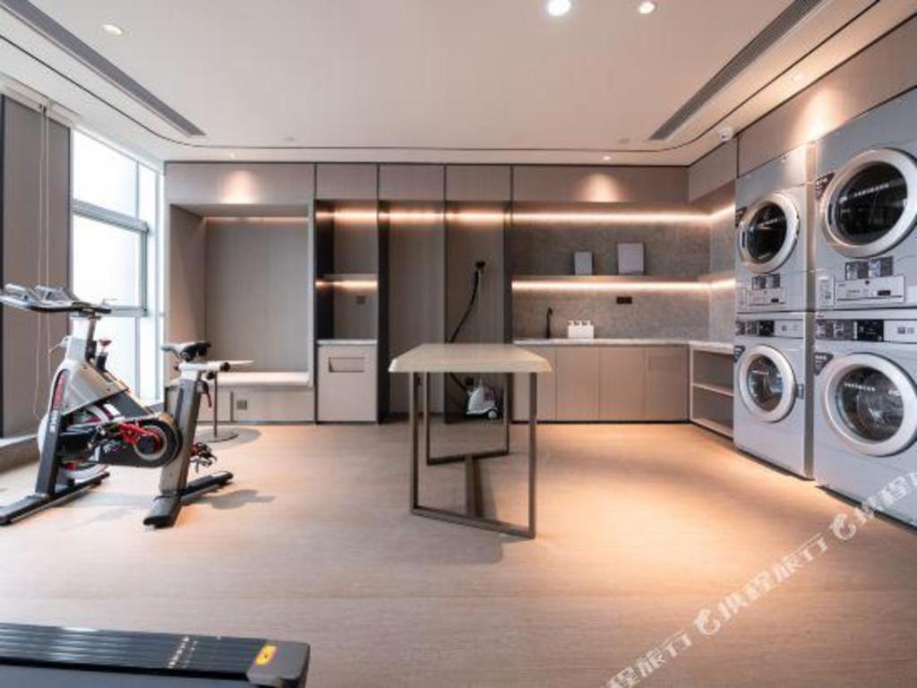 a room with a gym with machines and a treadmill at Ji Hotel Jiaxing Shanshan Impression Plaza in Jiaxing