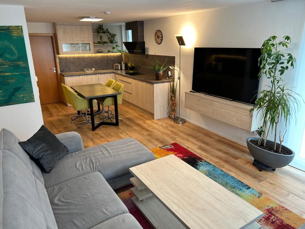 a living room with a couch and a table at TOP Ferienwohnung in Bad Urach