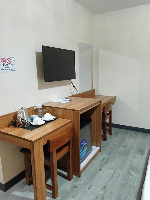 TV a/nebo společenská místnost v ubytování Norlu Cedec Midpoint Hotel