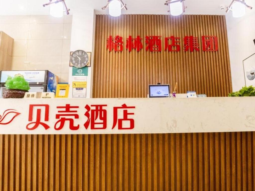 a store with a counter with writing on it at Shell Hotel Xinzheng Longhu Town Xiang'an Road in Guodian