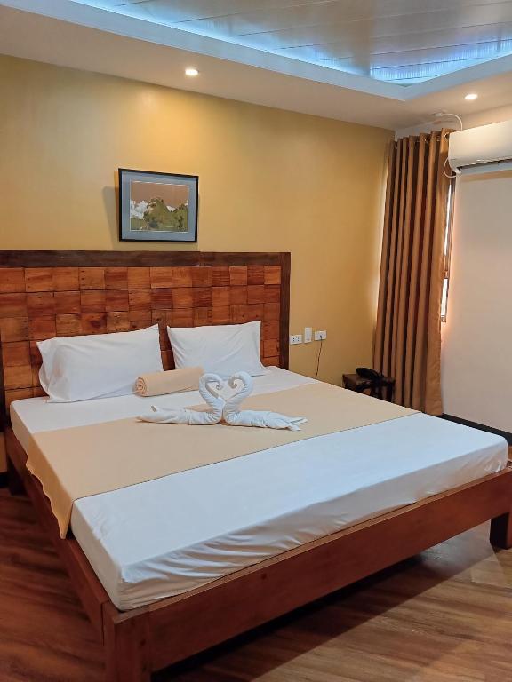 Postel nebo postele na pokoji v ubytování Norlu Cedec Midpoint Hotel