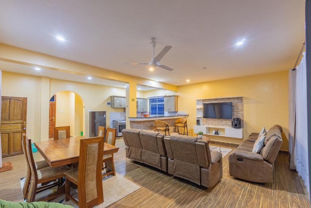 ein Wohnzimmer mit einem Tisch und einem Esszimmer in der Unterkunft Waiti homes in Diani Beach