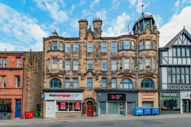 a large brick building on the corner of a street at Falkirk City Centre Stylish Two-Bedrooms Apartment in Falkirk