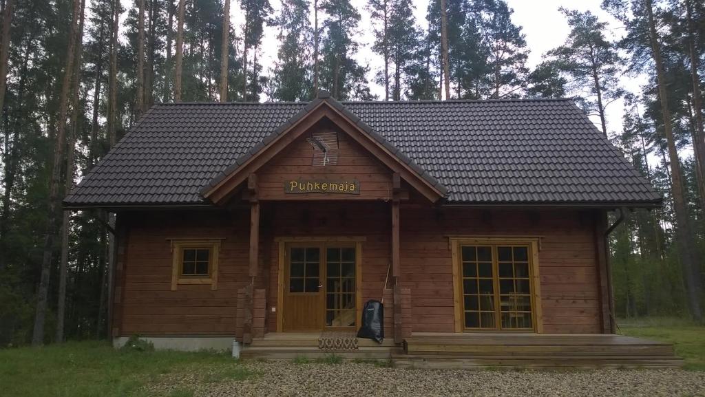 a small log cabin in the middle of a forest at Peko Holiday Home in Õrsava